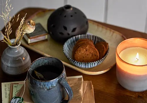 Bloomingville Wohnaccessoires mit Kerze, Tasse und Deko-Schale auf Holztablett – gemütliche Szene mit skandinavischem Flair
